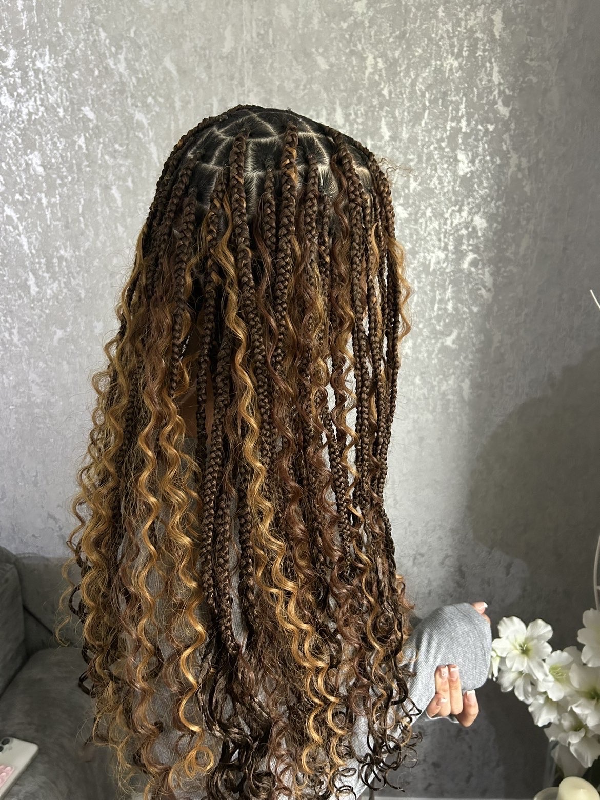 Editorial portrait of a model wearing long knotless braids